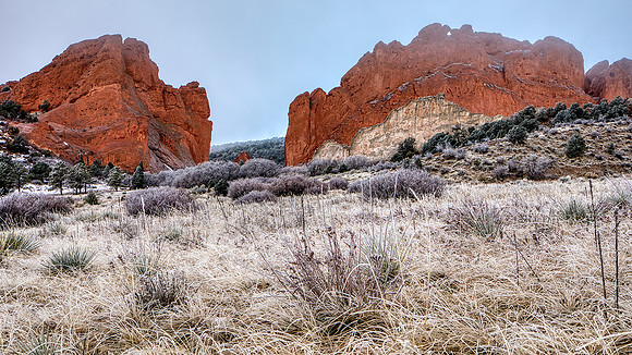The red rock formations of the Garden of Gods on a foggy, freezing cold, and icy morning.