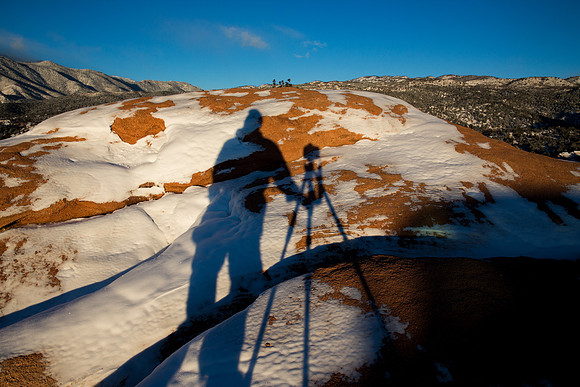 14.5 MB, 5184 x 3456: The shadow of a photographer, camera and tripod on the snow covered rocks of Garden of the Gods Park.