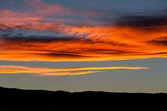 7.67 MB, 5184 x 3456: Red clouds as the sun sets behind silhouetted mountains.