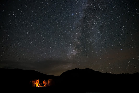 6.93 MB, 5184 x 3456: A warm glowing camp fire on a cold fall night under the Milky Way galaxy near Crested Butte, Colorado.