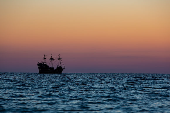 8.44 MB, 5008 x 3339: A silhouette of a three mast sailing ship as it heads out into the Gulf.