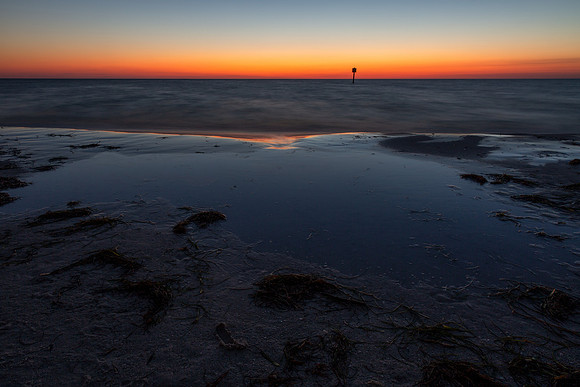 15.5 MB, 5760 x 3840: Sunset lights the sky a bright orange, red and yellow giving a feeling of calm.