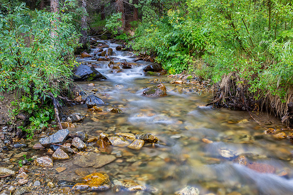 23.8 MB, 5760 x 3840: Relaxing mountain stream flows over rocks and through a forest