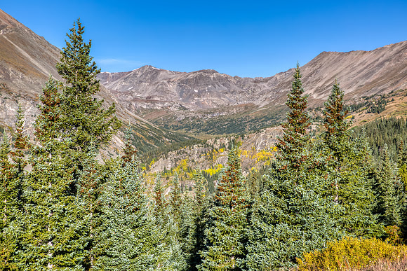 28.4 MB, 5760 x 3840: Steep mountain peaks and green pine trees near the summit of Hoosier Pass.