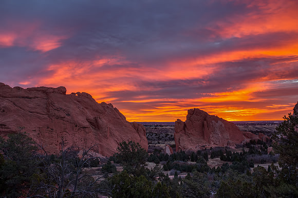 8.40 MB, 5184 x 3456: Sunrise over the red rocks of the Garden of Gods turns a cloudy sky red and orange.