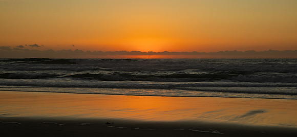 11.0 MB, 6337 x 2930: Beautiful orange sky as the sun sets into the Pacific on Mission Beach