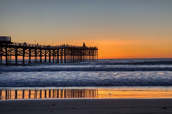 16.0 MB, 6232 x 4155: Orange sunset reflects of the surf and silhouettes Chrystal pier.